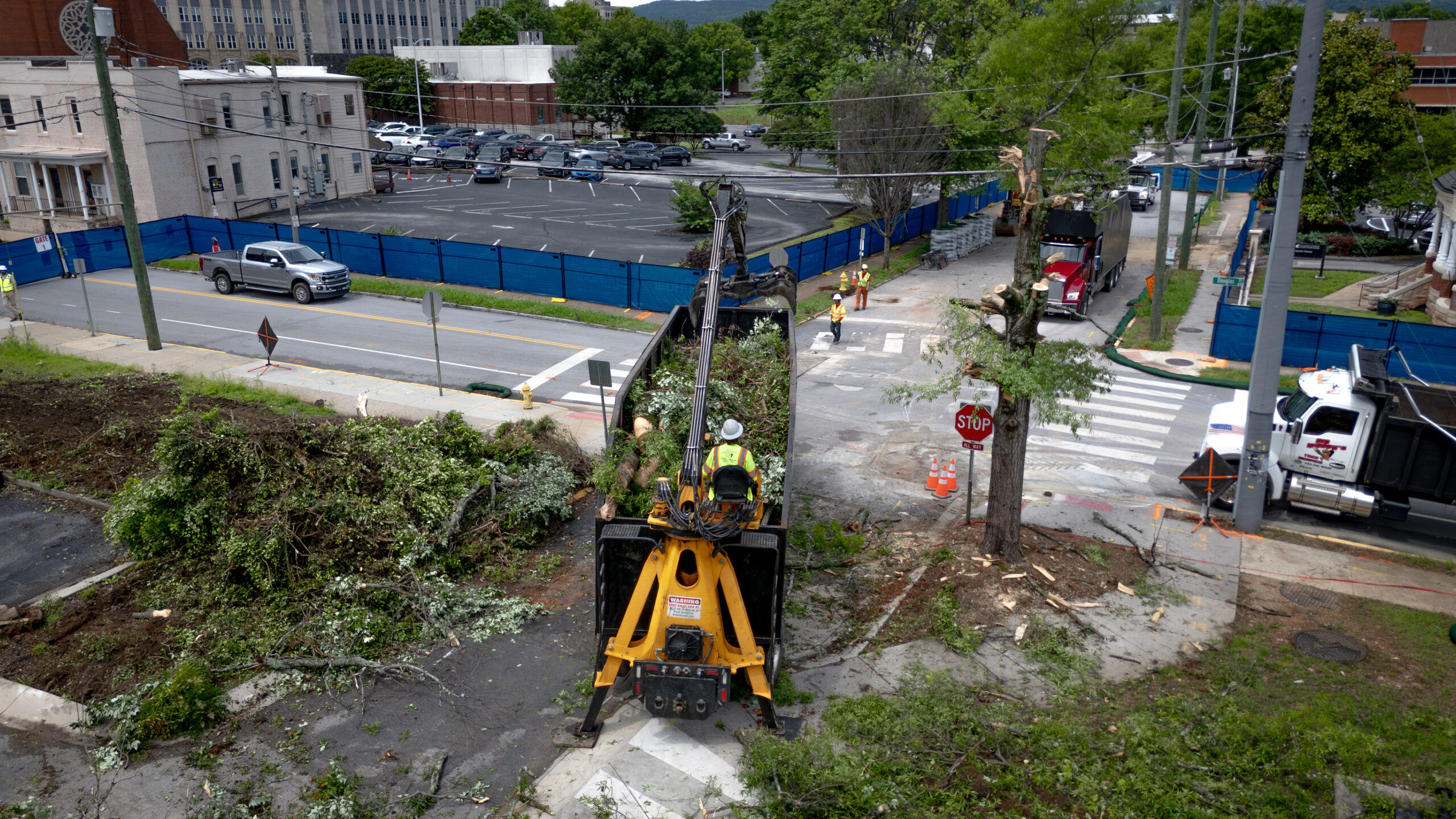 Big Woody's crew clearing downed trees with a grapple truck on a Chattanooga street